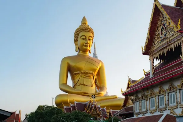 The golden Buddha at Wat Paknam above a Bangkok canal and longtail boats
