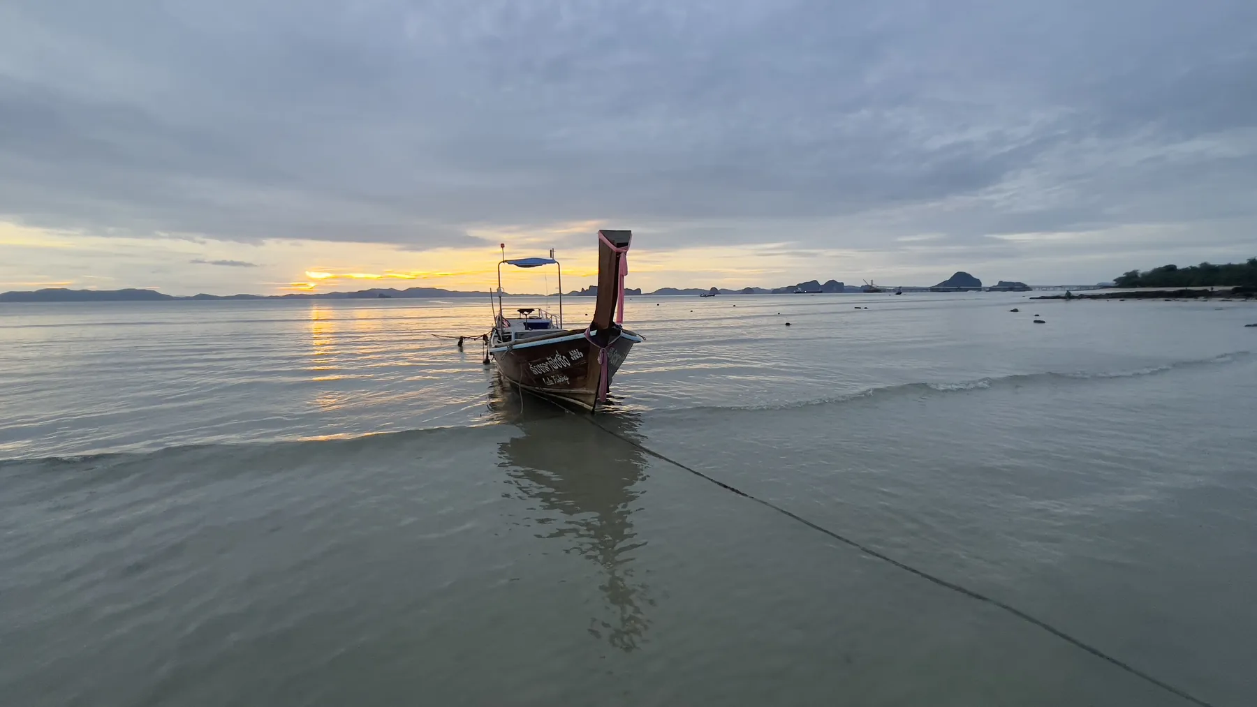 A longtail boat at sunset on Klong Muang Beach, Krabi