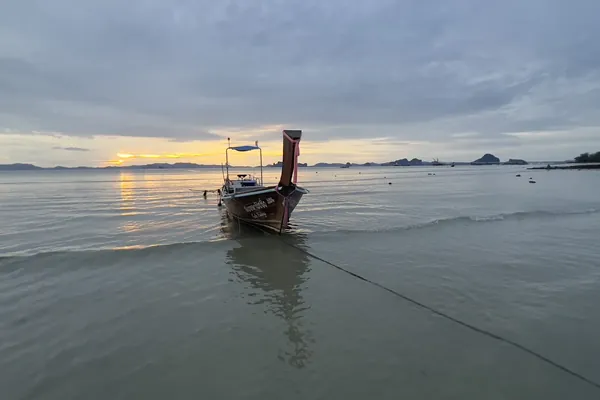 A longtail boat at sunset on Klong Muang Beach, Krabi