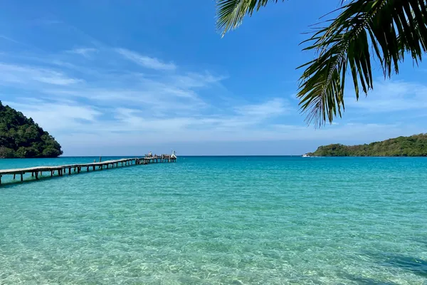 A wooden pier stretches over clear turquoise water at Koh Kood