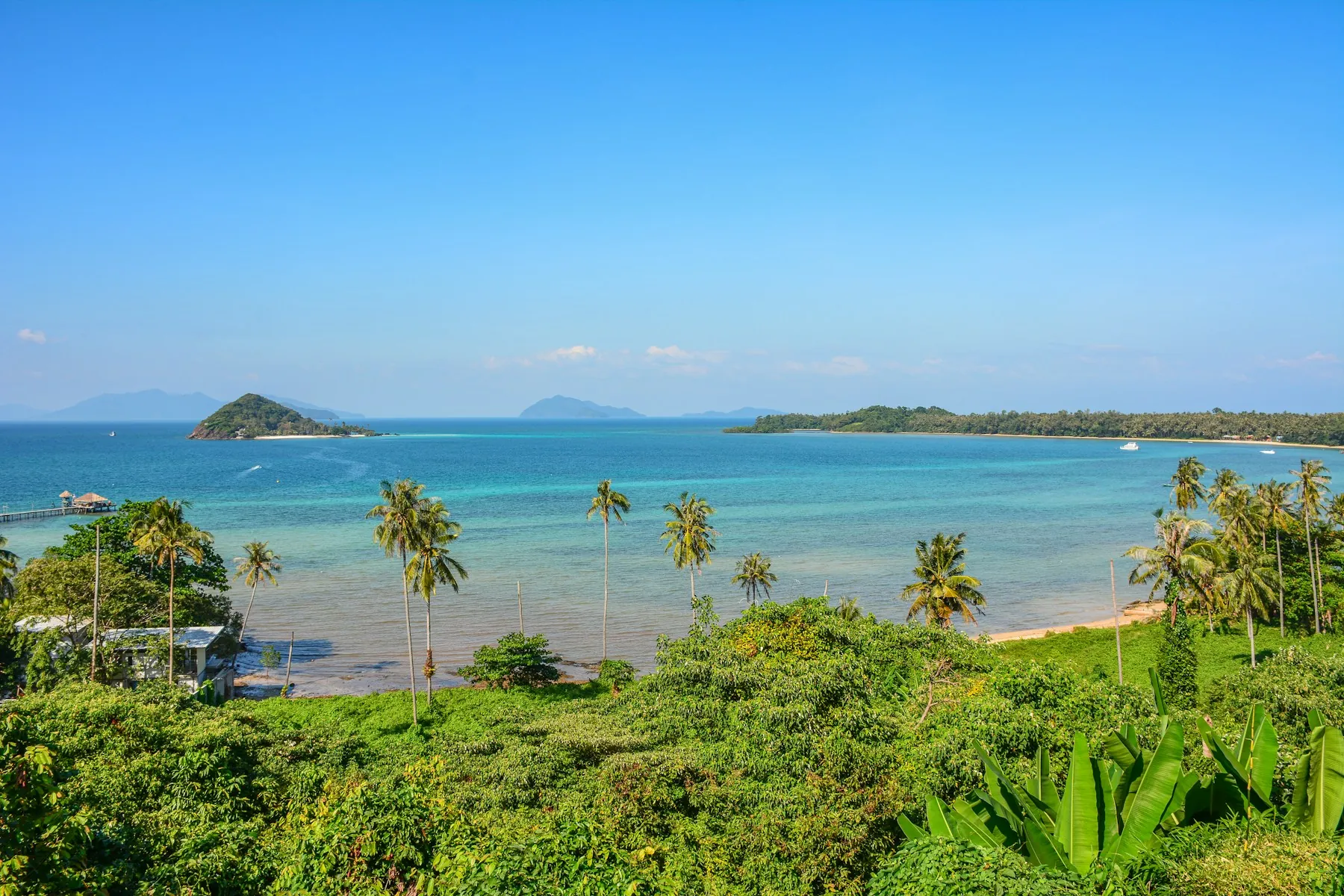 The Koh Mak coastline with palm trees and nearby islets