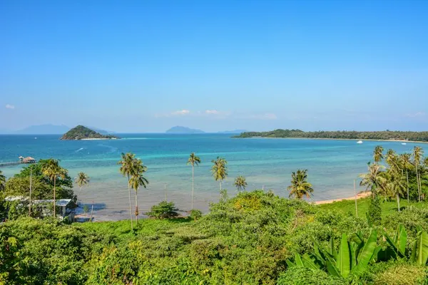 The Koh Mak coastline with palm trees and nearby islets