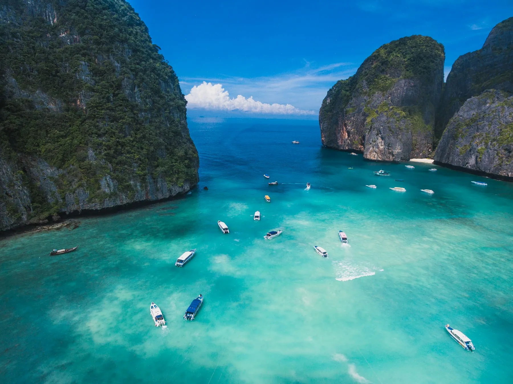 Longtail boats on turquoise water in Maya Bay, Phi Phi Islands