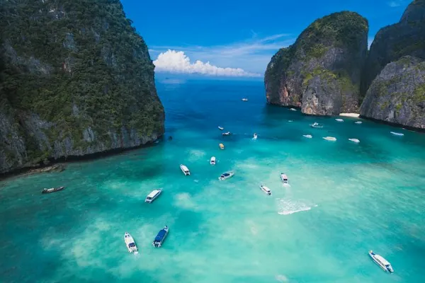 Longtail boats on turquoise water in Maya Bay, Phi Phi Islands